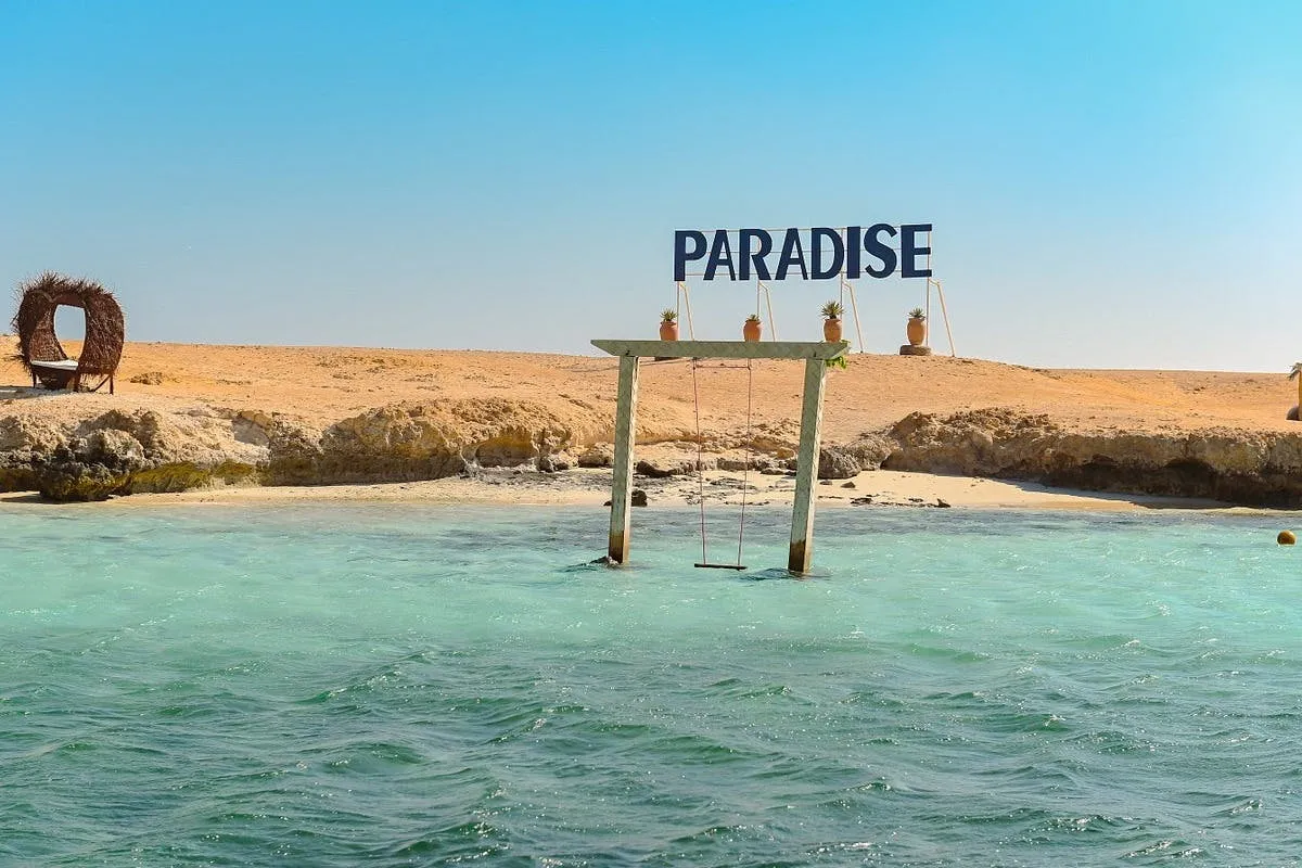 Paradise Island Hurghada beach with turquoise water and wooden swing